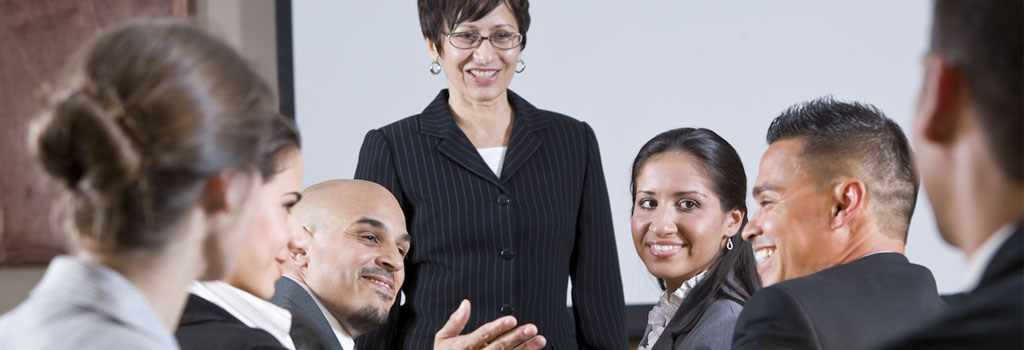 Image of business people having a conversation with the head of the meeting.